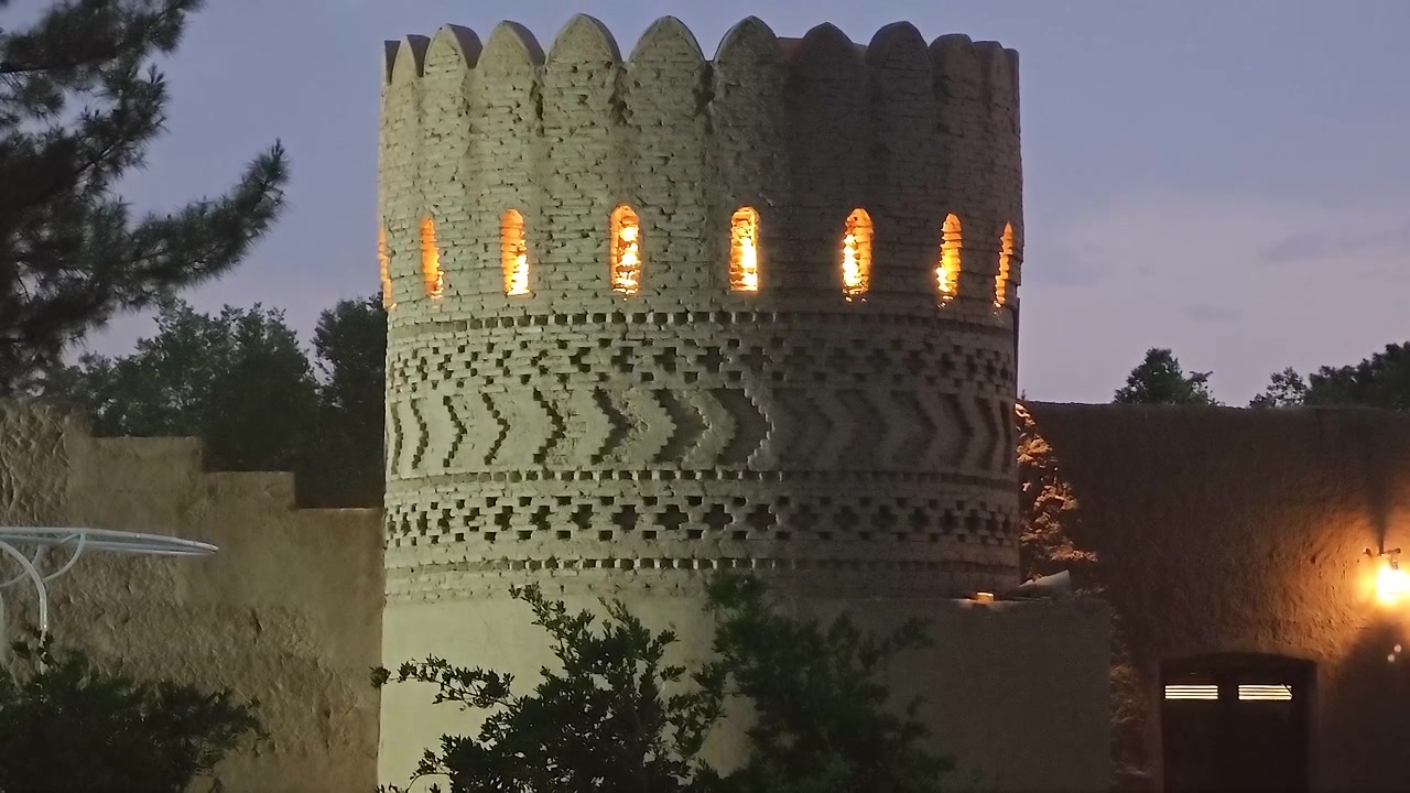 Illuminated Ancient Brick Tower at Twilight