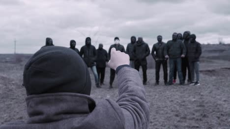 group of masked men being pointed at