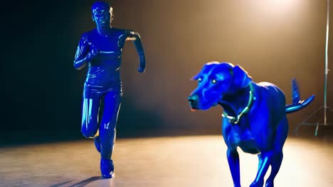 woman and dog in blue suits running in a studio