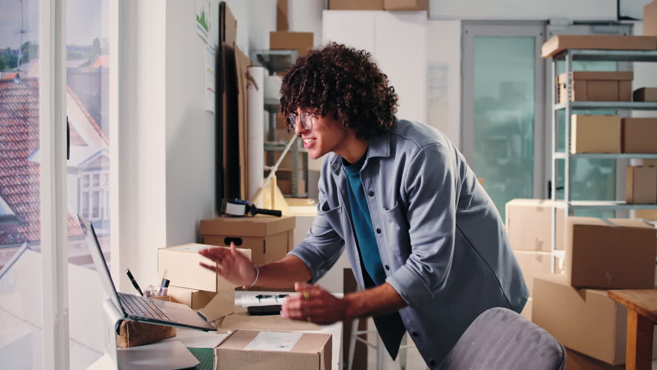 Happy Young Entrepreneur Working on Laptop and Celebrating Success