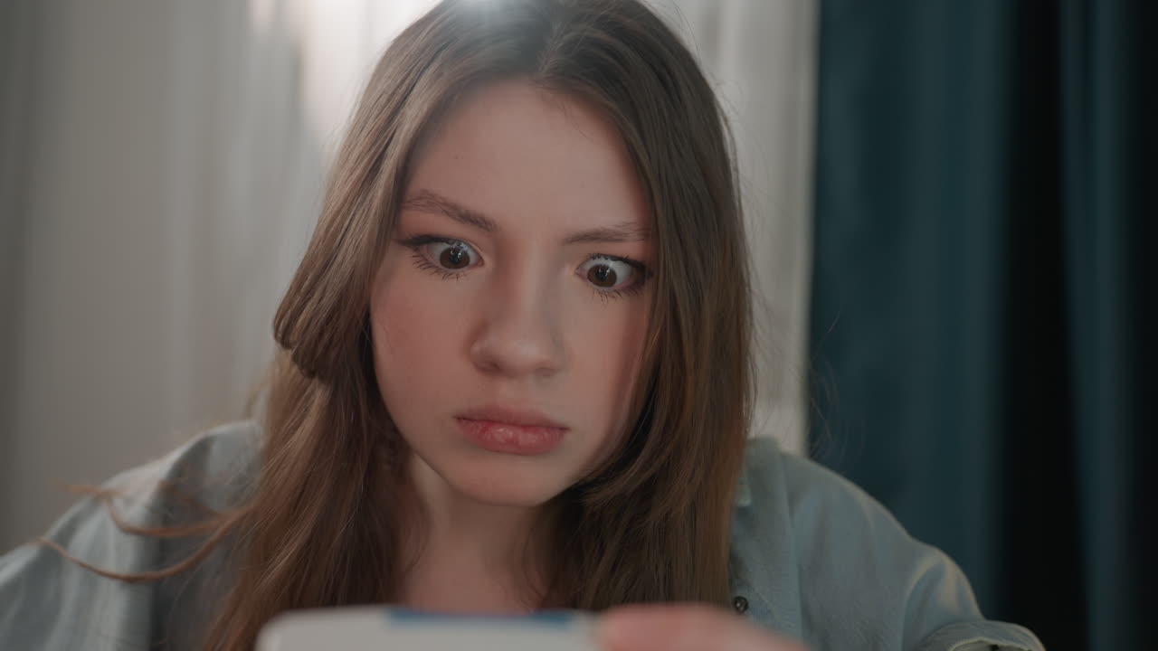 Caucasian woman reacting to monitor reading with shocked expression in soft bedroom light, worried patient moment, office worker role and solo check scenario, closeup emotion and tense gaze