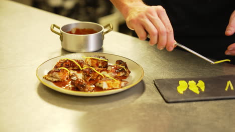 chef uses tweezers to garnish lemongrass on tasty fried chicken with precision