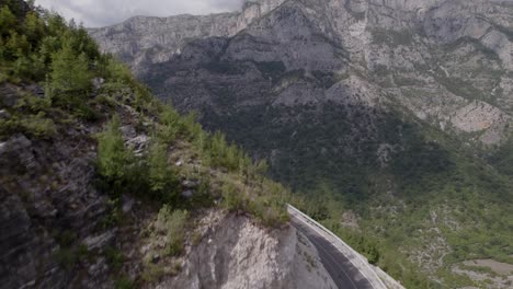 drone video of ascending frontal discovery plane over the mountain pass "rrapsh serpentine" on the sh20 road in grabom, albania, ends in front of the mountain leqet e hotit