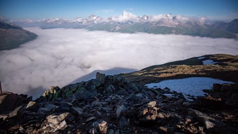 panoramic wide angle timelapse of a dynamic layer of morning fog moving in oberengadin valley seen from segantini hut above pontresina in directon of maloja pass