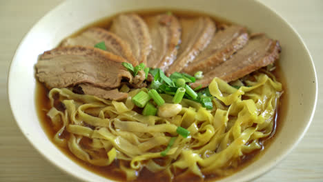 egg noodles with stewed duck in brown soup - asian food style-1