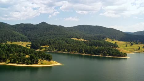 slow aerial pan over dospat dam resrervoir with shoreline sheltered inlets,rhodopes bulgaria