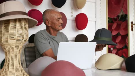 mixed race man working at a hat factory