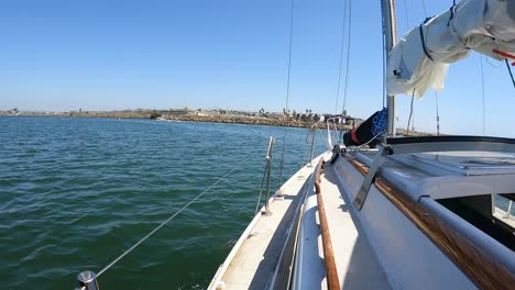 riding in a sailboat down a marina