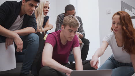 Group Of College Students In Shared House Bedroom Studying Together