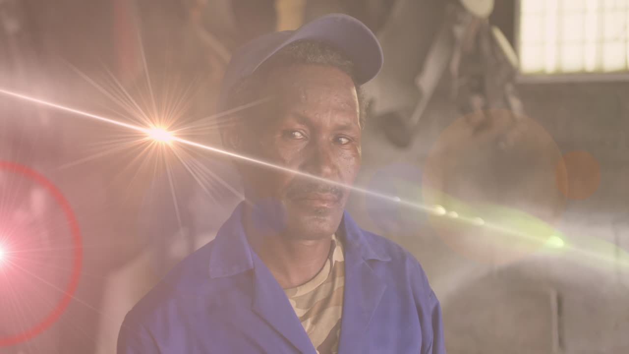 Man standing inside industrial workshop, displaying animated business chart overlays and lens flare
