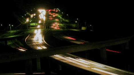 vehicles drive on a freeway at night in fast motion 4