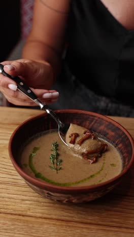 woman eating mushroom soup