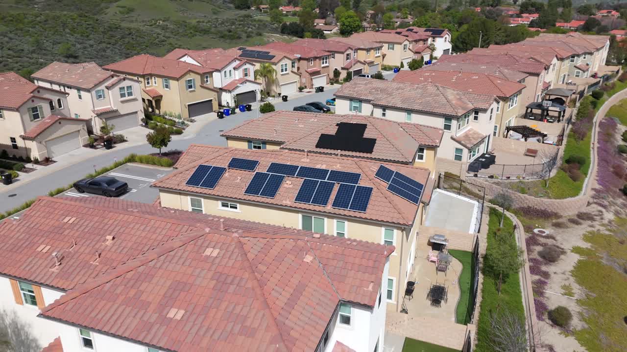 Dramatic aerial shot of solar panels on neighborhood roof of residential house in Santa Clarita, green energy