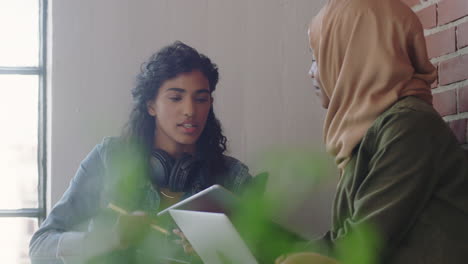 multi-ethnic-business-team-brainstorming-creative-women-sharing-ideas-working-together-diverse-colleagues-collaborating-enjoying-teamwork-using-technology-in-relaxed-office-workplace