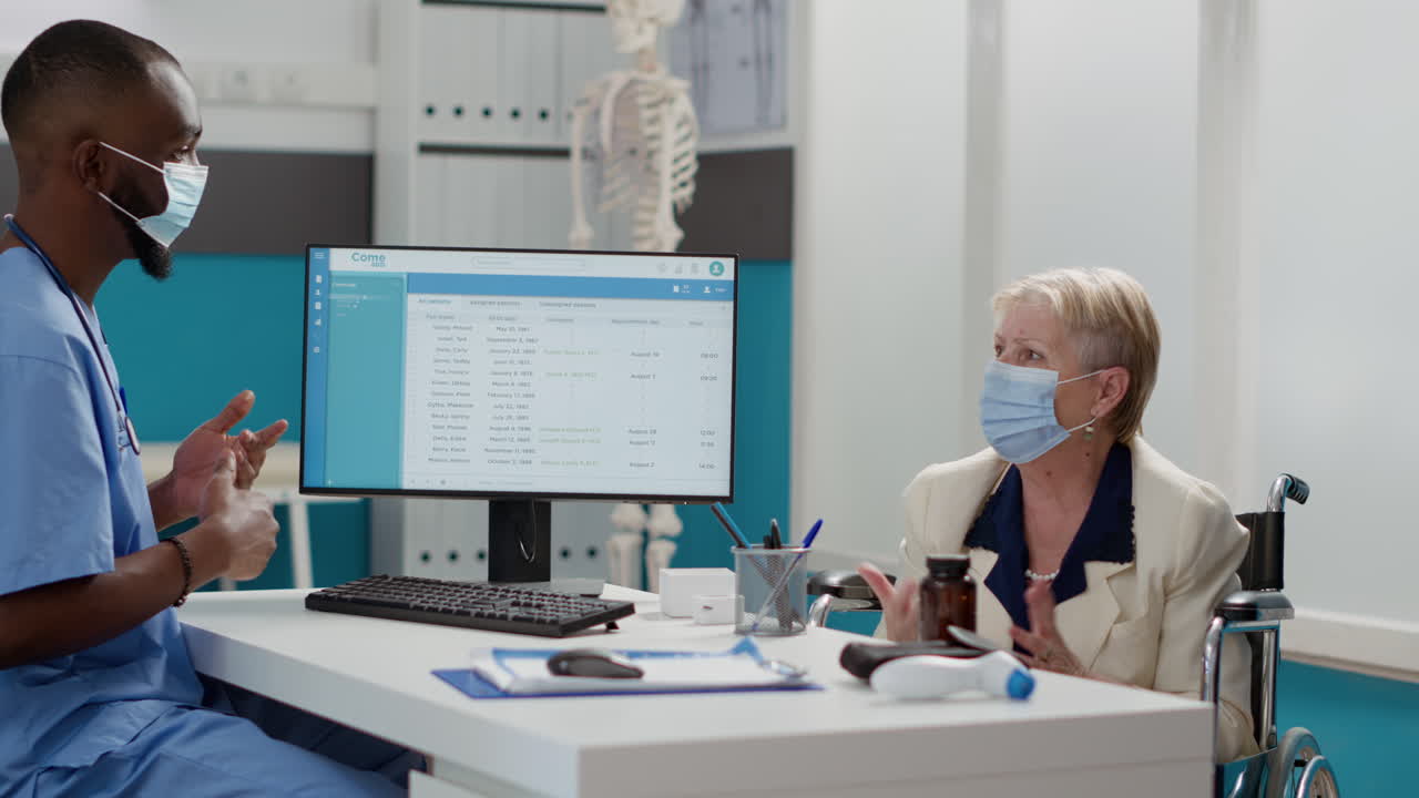 Doctor consulting with elderly patient in hospital