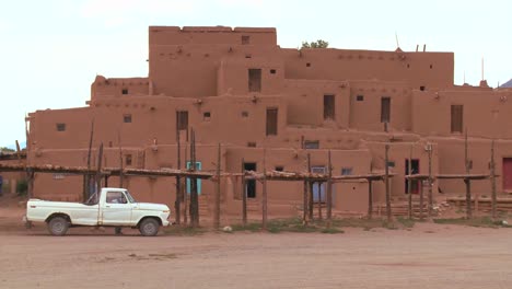 Old-white-pickup-truck-in-front-of-the-Taos-pueblo-in-New-Mexico