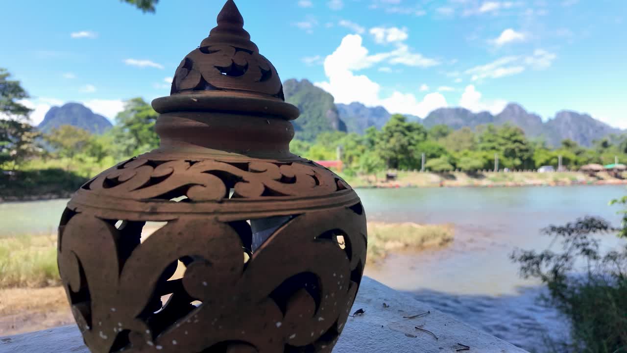 Ornate Stone Ornament Overlooking Nam Song River in Vang Vieng Laos With Mountain Views