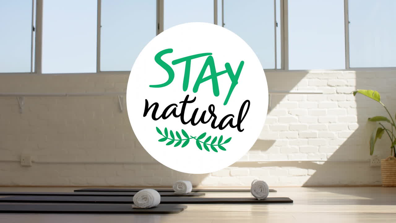 Stay natural text animation over yoga mats and towels in bright studio