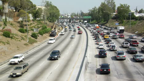 traffic moves slowly along a busy freeway in los angeles