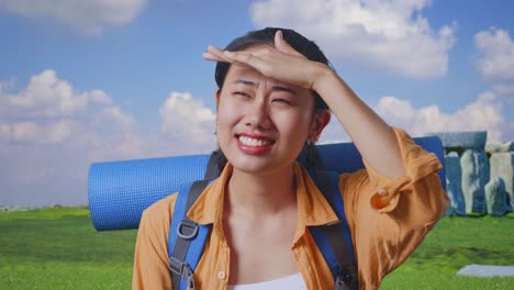 close up of asian female hiker with mountaineering backpack hand forehead smiling and looking distance while traveling in stonehenge
