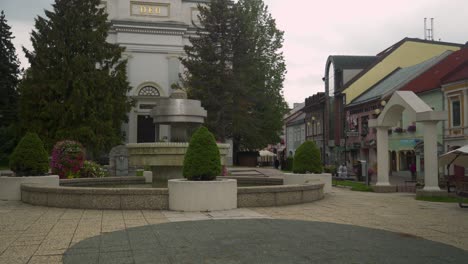 church in the middle of town shot revealing fountains