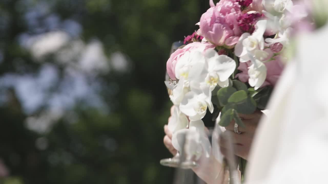 Bride with bouquet and wine glass