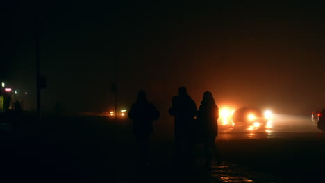 people walking in foggy night