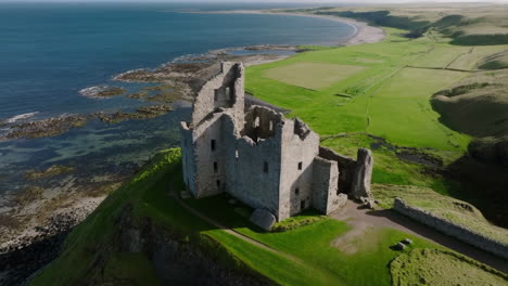 ancient castle ruins on a cliff overlooking the coast