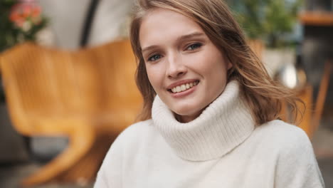 caucasian woman smiling at the camera.