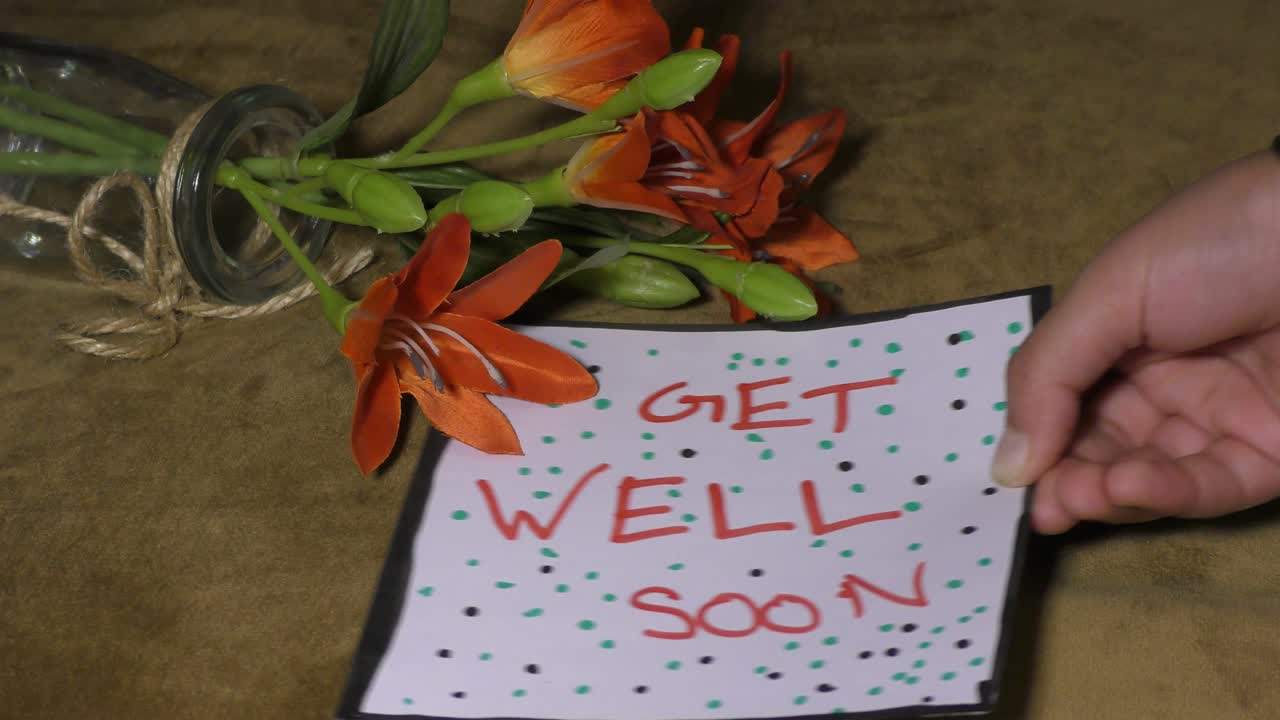 Get well soon with red flowers and card