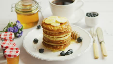 pancakes with slices of banana and berries