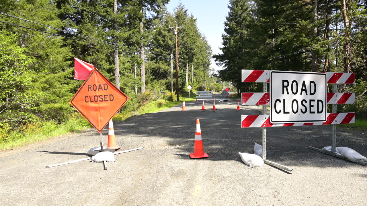 Road Closure signs on a residential street due to a broken culvert.