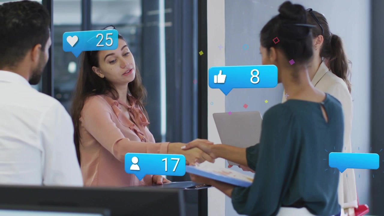 Diverse coworkers shaking hands at office, pink top folder, teal top clipboard, reaction bubbles