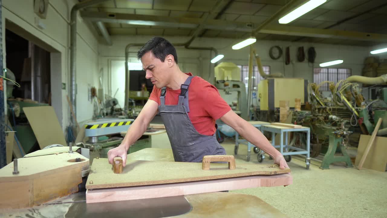 Man operating a woodworking machine in a workshop