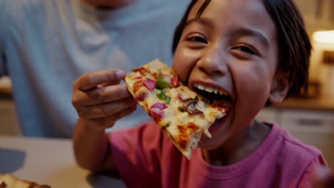 family enjoying pizza dinner
