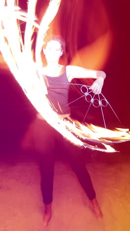 a woman does a fire performance in vertical