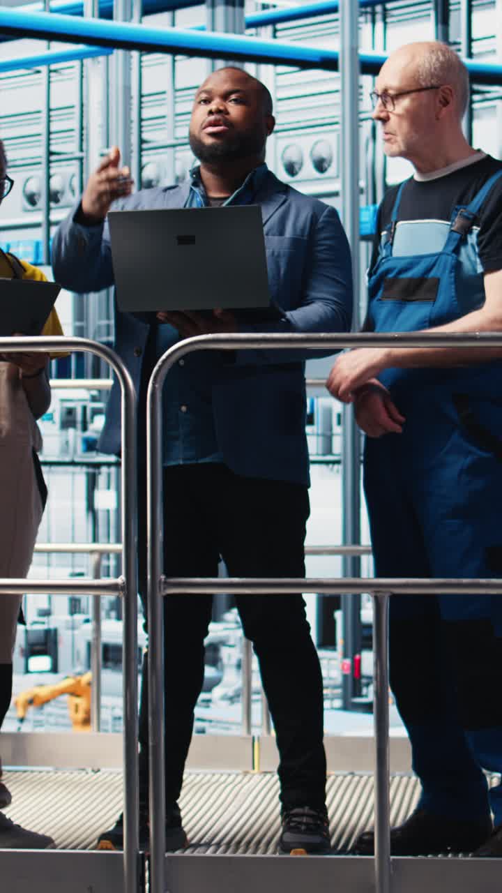 Vertical video Smart factory manager discussing with employees