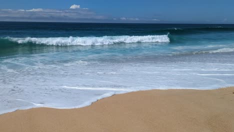 light surf at north beach praia do norte on a sunny and idyllic day