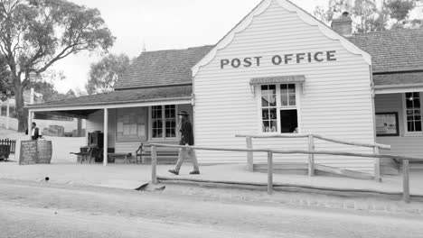 individual walking by historic post office building