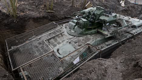 tilt-down view of a russian bmd-4m, an airborne assault vehicle designed for rapid attacks, is seen here in a static defensive trench—a sign of the current reality of the war in ukraine