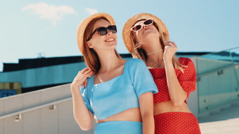 two happy women laughing outdoors