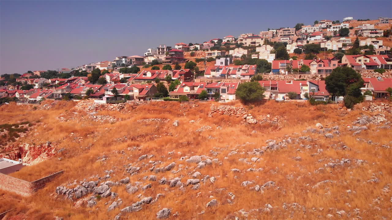 Small Village with red rooftops in the desert Heat Aerial