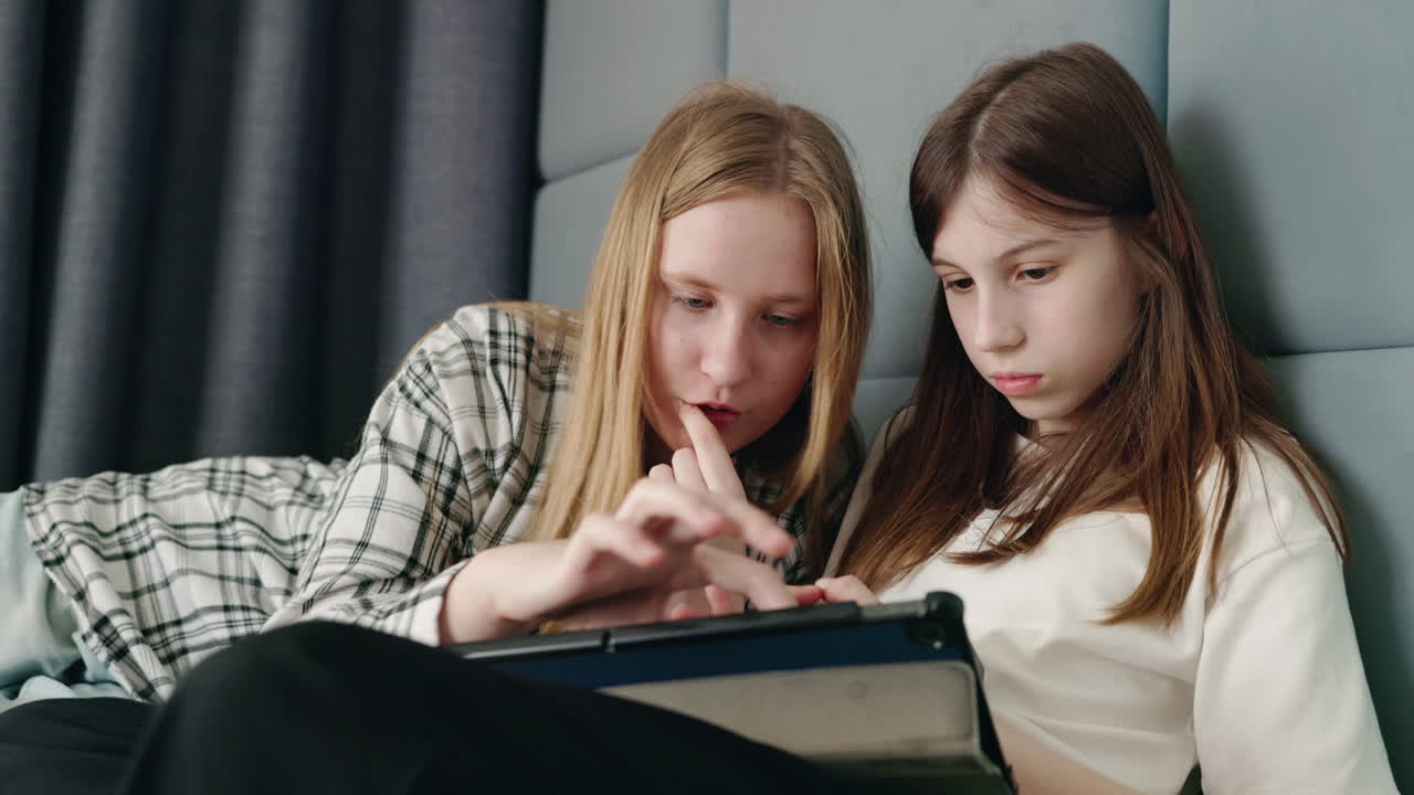 Teenage girls using a tablet