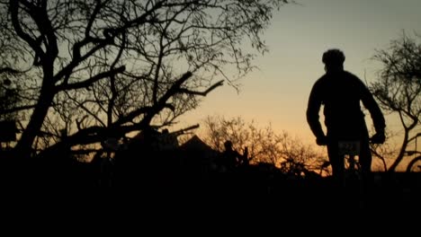 A-mountain-bike-rider-takes-off-down-a-trail