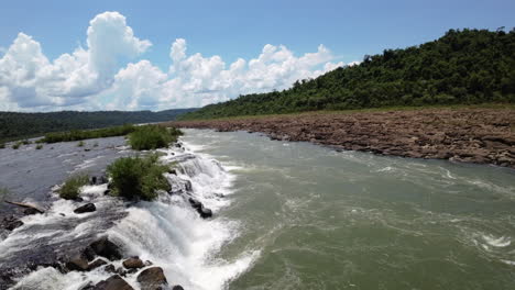 aerial fpv view of mocona falls over rocky terrain in lush argentine jungle