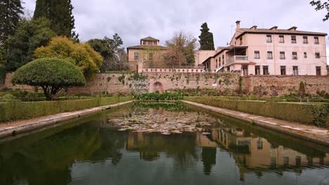 beautiful pond in the gardens of alhambra, granada spain jardines del paraiso