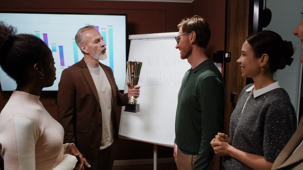 Business Colleagues Celebrate Award Winner with Applause and Handshake