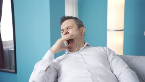 the man who yawns in his seat falls asleep.