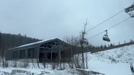 gray lift station in winter at the end of ski season