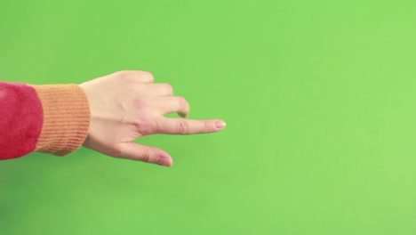 man hand in studio isolated on green screen. hand pointing on background